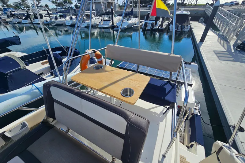 Slide: The Image of 2015 Cutwater 30 Command Bridge at marina, featuring seating and table on deck. - 15