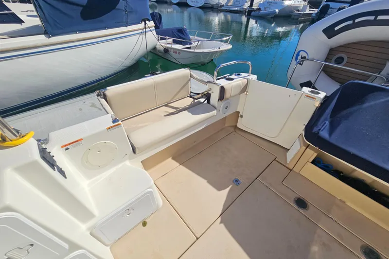 Slide: The Image of 2015 Cutwater 30 Command Bridge boat interior with seating and docked at marina. - 19
