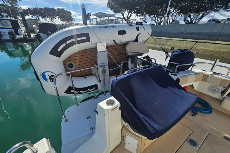 Slide: The Image of 2015 Cutwater 30 Command Bridge with inflatable boat at marina dock. - 22