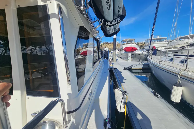 Slide: The Image of 2015 Cutwater 30 Command Bridge docked at marina, surrounded by other boats. - 27