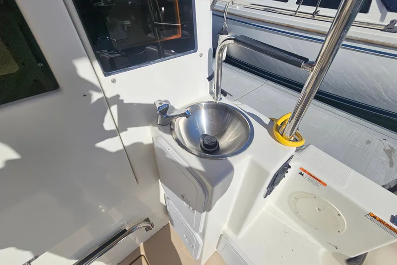 Slide: The Image of 2015 Cutwater 30 Command Bridge boat sink and deck area. - 28