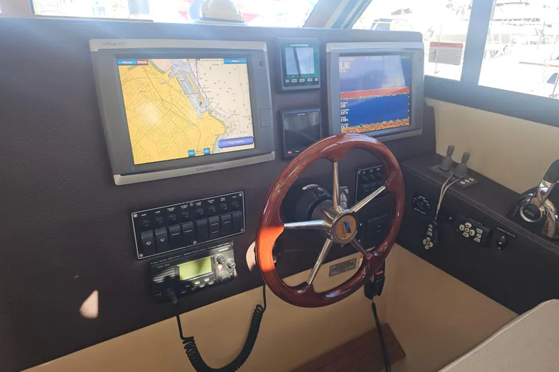 Slide: The Image of Helm of 2015 Cutwater 30 Command Bridge with navigation screens and controls. - 32