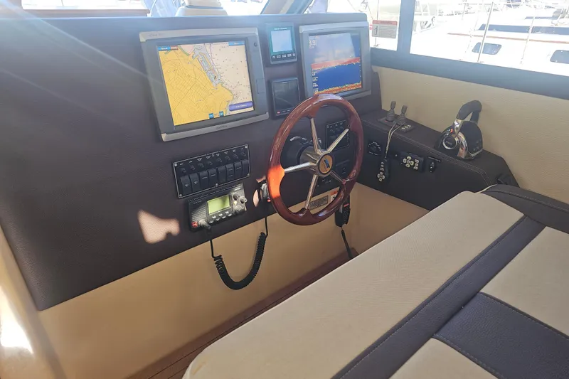 Slide: The Image of Helm of 2015 Cutwater 30 Command Bridge with navigation screens and controls. - 33