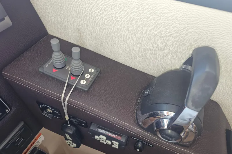 Slide: The Image of Control panel of a 2015 Cutwater 30 Command Bridge boat with joystick and throttle. - 36