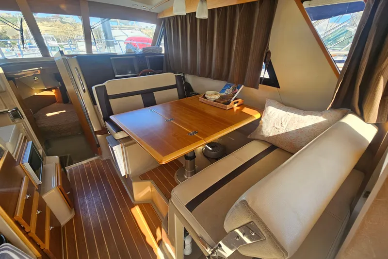 Slide: The Image of Interior of 2015 Cutwater 30 Command Bridge with dining area and wood accents. - 39