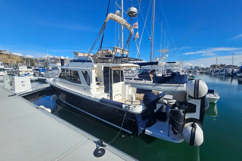 Slide: The Image of 2015 Cutwater 30 Command Bridge docked at a marina under clear blue skies. - 4