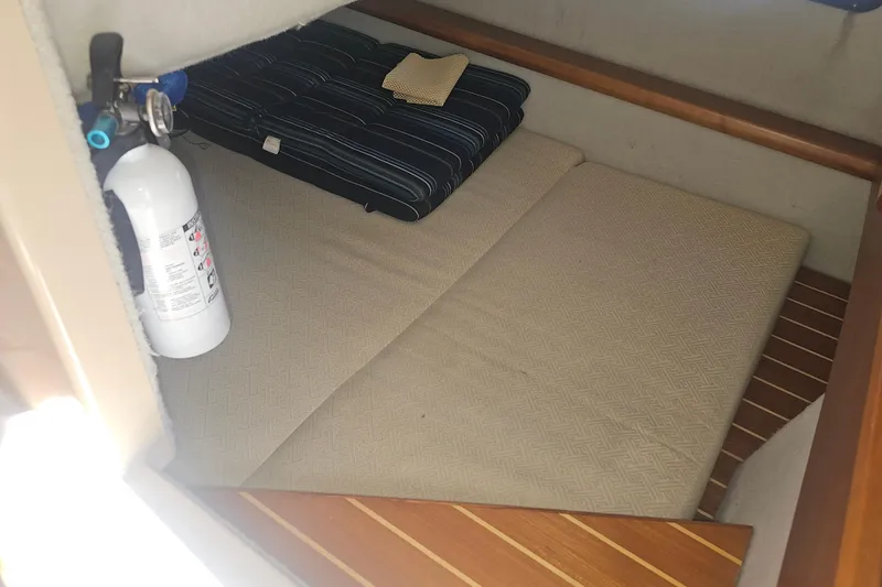 Slide: The Image of 2015 Cutwater 30 Command Bridge cabin interior with fire extinguisher and bedding. - 42