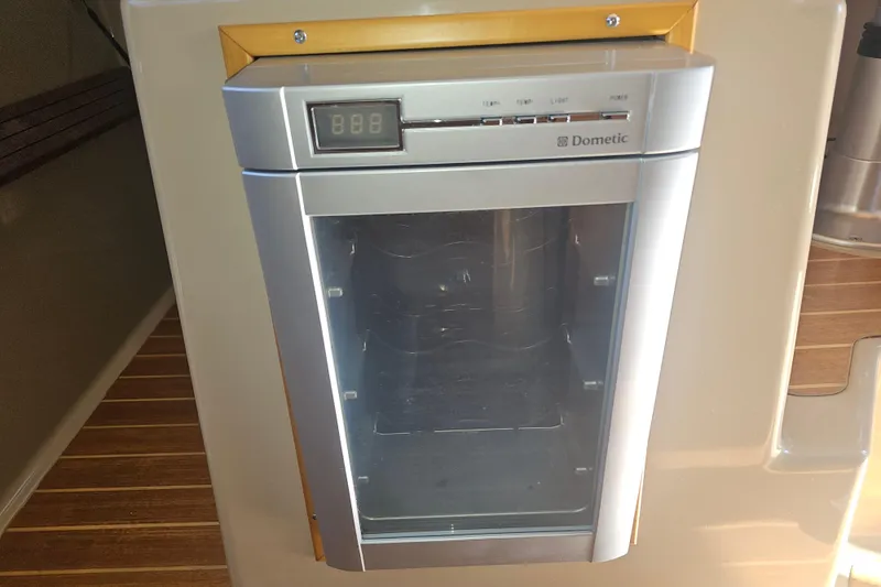 Slide: The Image of Dometic fridge in 2015 Cutwater 30 Command Bridge boat interior. - 44