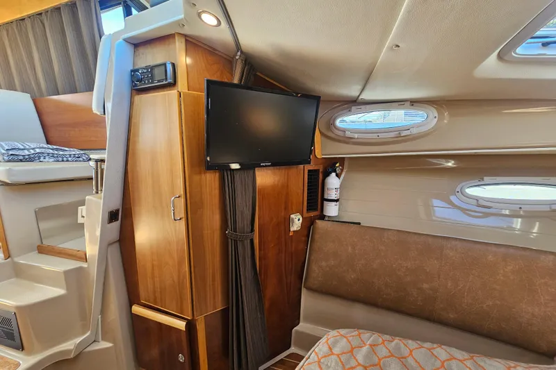 Slide: The Image of Interior of 2015 Cutwater 30 Command Bridge with TV, seating, and portholes. - 46