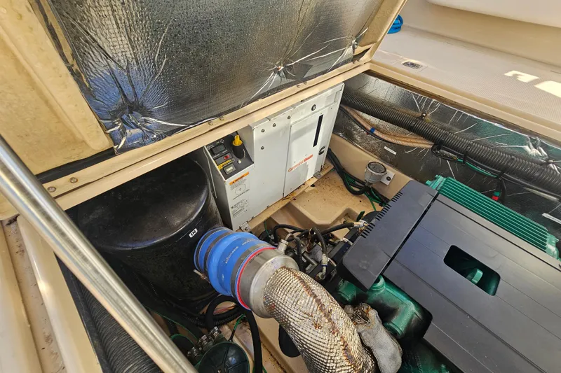 Slide: The Image of Engine compartment of a 2015 Cutwater 30 Command Bridge boat, showing mechanical components. - 62