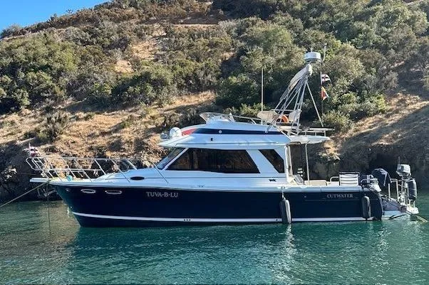 Slide: The Image of 2015 Cutwater 30 Command Bridge boat anchored in scenic coastal waters. - 64