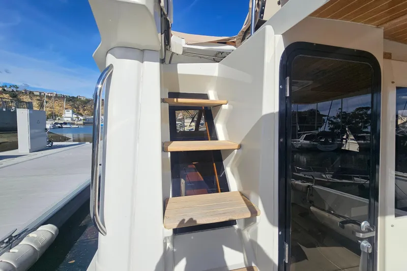 Slide: The Image of Staircase on 2015 Cutwater 30 Command Bridge yacht, leading to upper deck, docked at marina. - 9