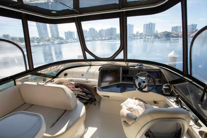 Slide: The Image of Interior of 2012 Carver Sojourn yacht with city skyline view through large windows. - 17