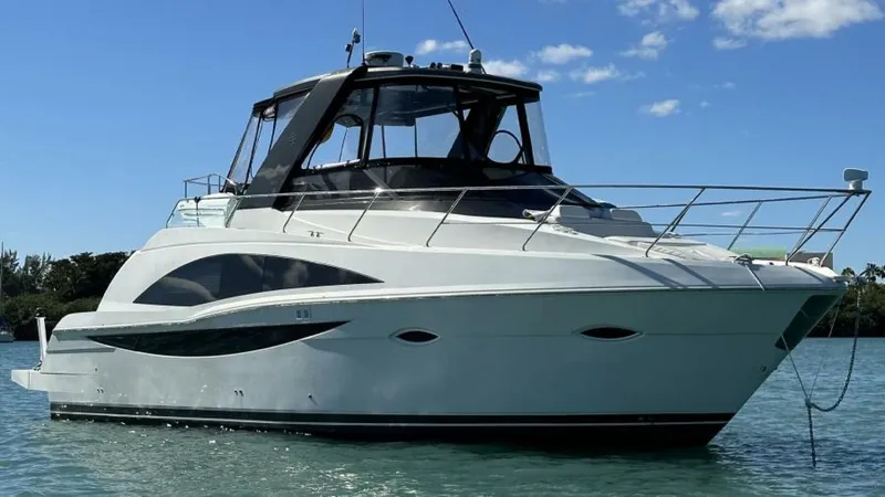 Slide: The Image of 2012 Carver Sojourn yacht on calm water under clear blue sky. - 2