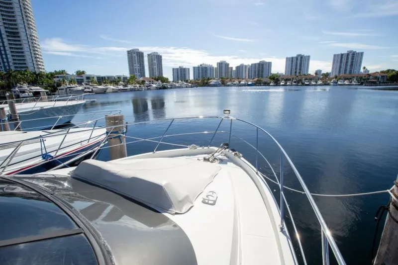 Slide: The Image of 2012 Carver Sojourn yacht docked in a marina with city skyline in the background. - 21