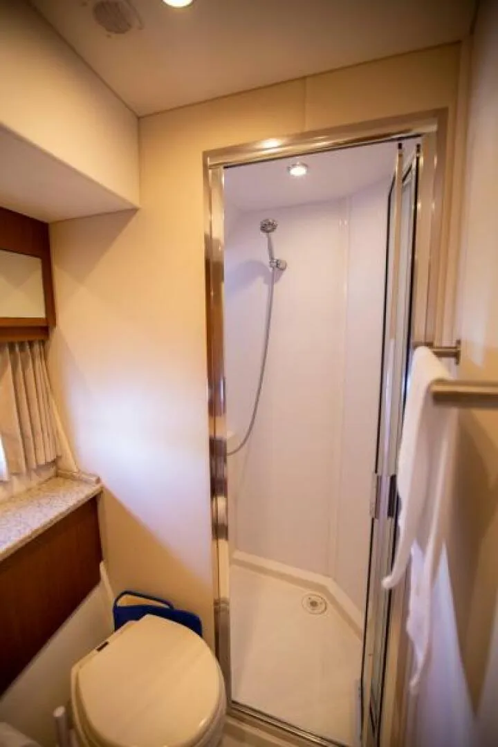 Slide: The Image of 2012 Carver Sojourn yacht bathroom with shower, toilet, and towel rack. - 28