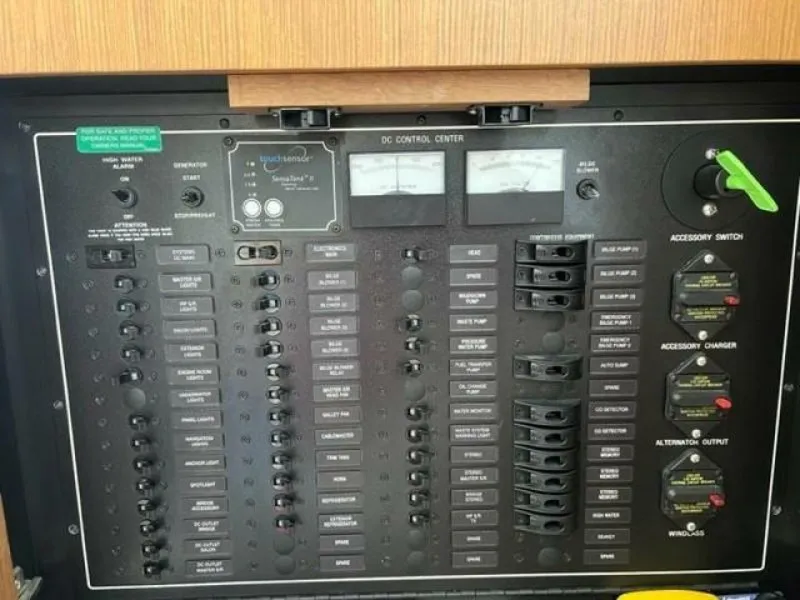 Slide: The Image of Electrical control panel on a 2012 Carver Sojourn boat, featuring switches and meters. - 32