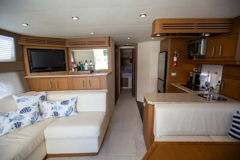 Slide: The Image of Luxurious interior of 2012 Carver Sojourn yacht with modern kitchen and cozy seating area. - 22
