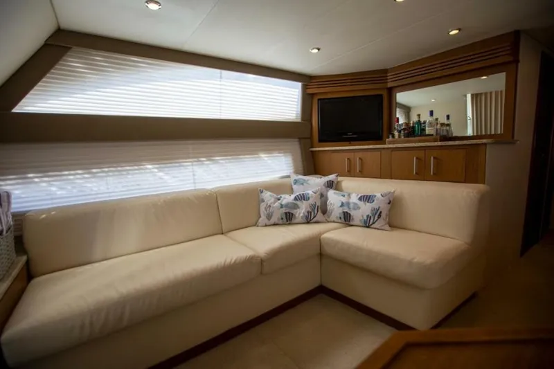 Slide: The Image of Luxurious interior of 2012 Carver Sojourn yacht with cream sofa and decorative pillows. - 25