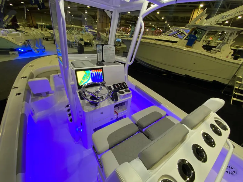 Slide: The Image of 2025 Caymas 26 HB boat interior with illuminated cockpit and modern navigation system. - 12