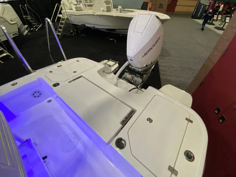 Slide: The Image of 2025 Caymas 26 HB boat with Mercury outboard engine, illuminated deck, and sleek design. - 13