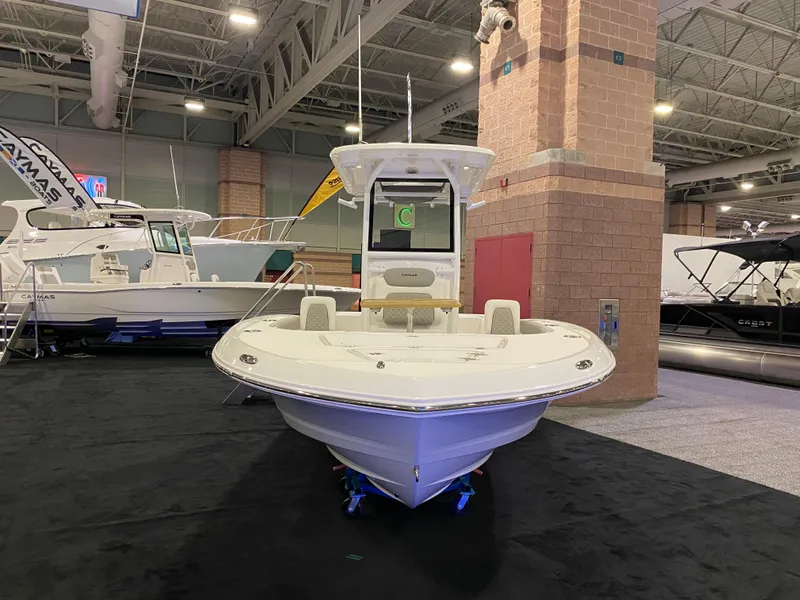 Slide: The Image of 2025 Caymas 26 HB boat displayed indoors at a boat show. - 2