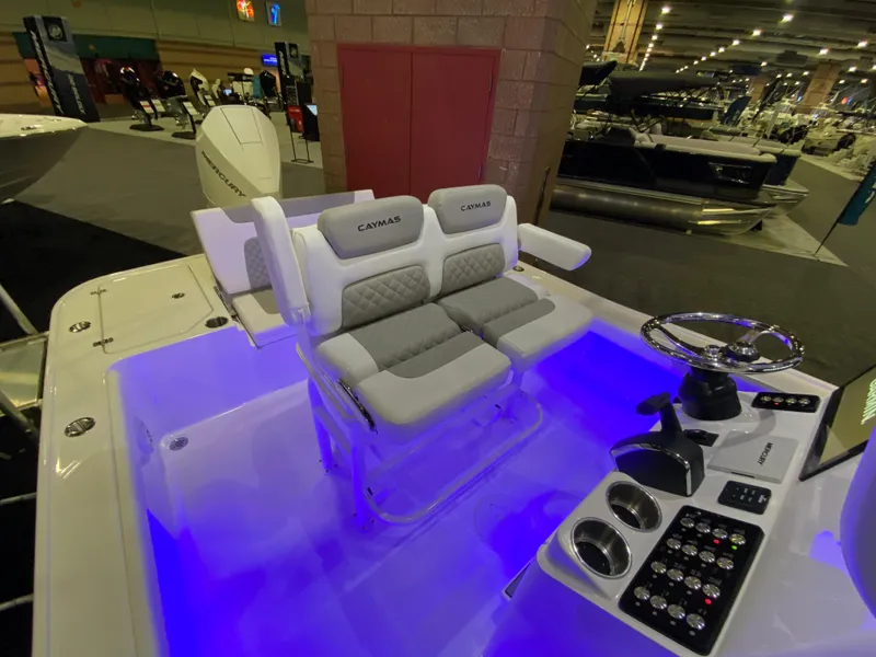 Slide: The Image of 2025 Caymas 26 HB boat interior with illuminated seating and modern control panel. - 7