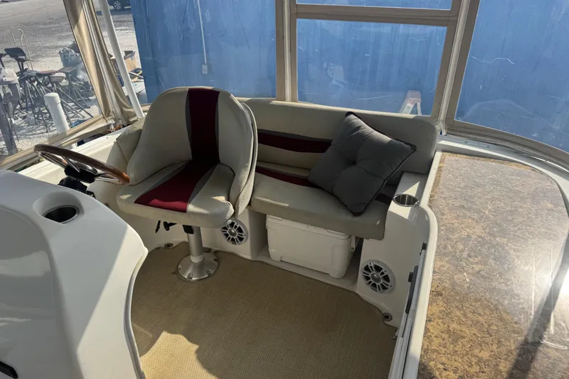 Slide: The Image of 2019 ElectraCraft 182TR boat interior with cushioned seating and steering wheel. - 6