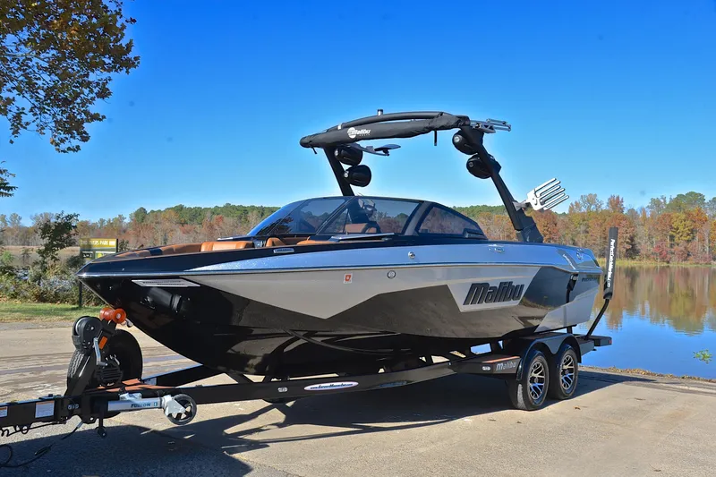 Slide: The Image of 2023 Malibu Wakesetter 23 LSV boat on trailer by a scenic lake. - 10