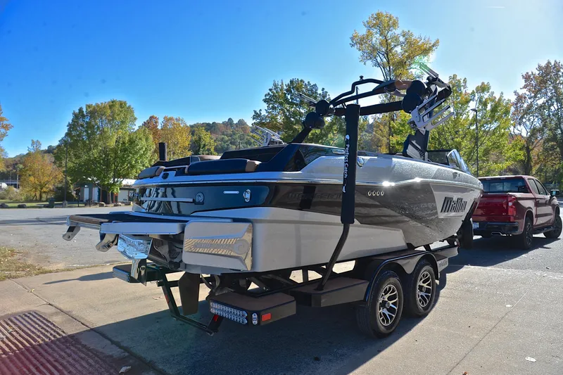 Slide: The Image of 2023 Malibu Wakesetter 23 LSV boat on trailer, parked outdoors on a sunny day. - 14