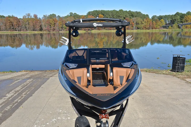Slide: The Image of 2023 Malibu Wakesetter 23 LSV boat on trailer by a scenic lake. - 17