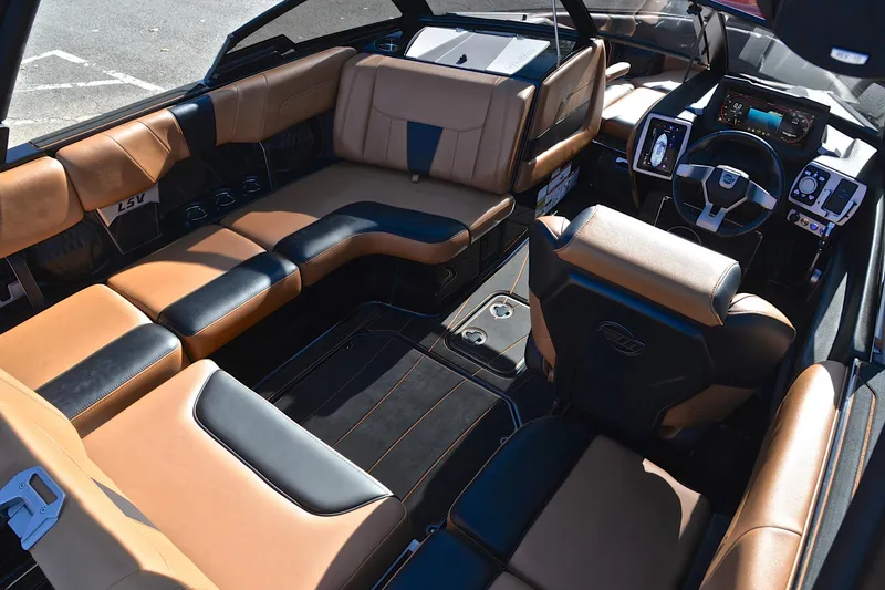 Slide: The Image of 2023 Malibu Wakesetter 23 LSV interior with luxurious tan and black seating. - 24
