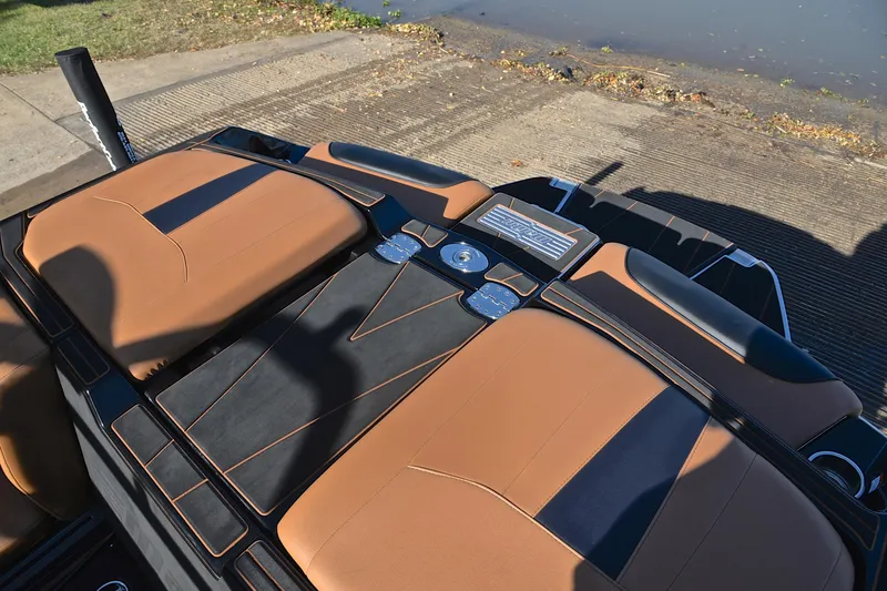 Slide: The Image of 2023 Malibu Wakesetter 23 LSV boat interior with tan and black seating. - 25