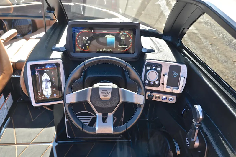 Slide: The Image of 2023 Malibu Wakesetter 23 LSV dashboard with advanced digital controls and steering wheel. - 26
