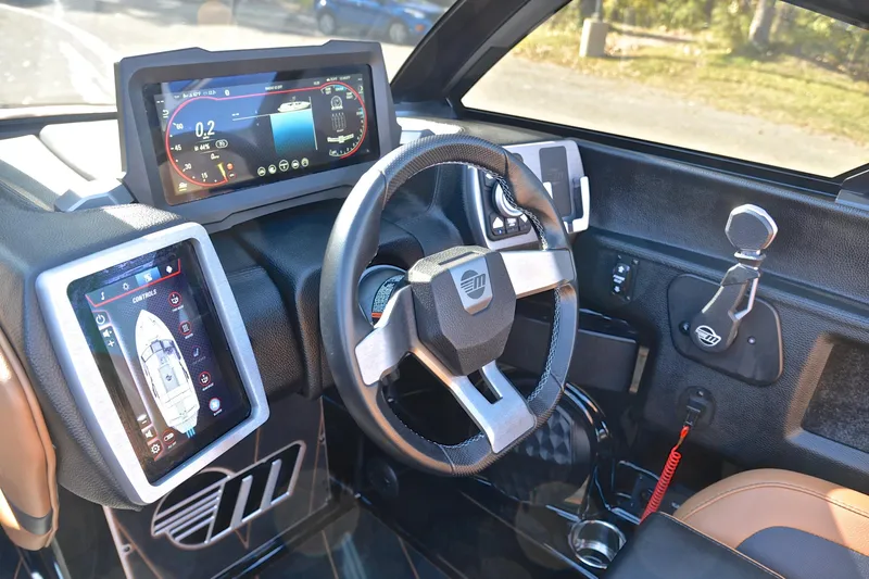 Slide: The Image of 2023 Malibu Wakesetter 23 LSV dashboard with advanced digital controls and steering wheel. - 27