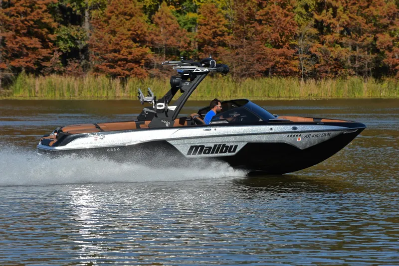 Slide: The Image of 2023 Malibu Wakesetter 23 LSV cruising on a lake with autumn foliage backdrop. - 3