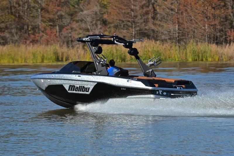 Slide: The Image of 2023 Malibu Wakesetter 23 LSV speeding on a lake with autumn trees in the background. - 4