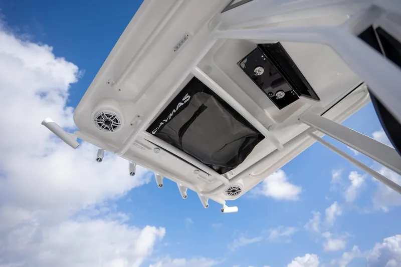 Slide: The Image of 2025 Caymas 291 boat roof with speakers and storage against blue sky. - 11