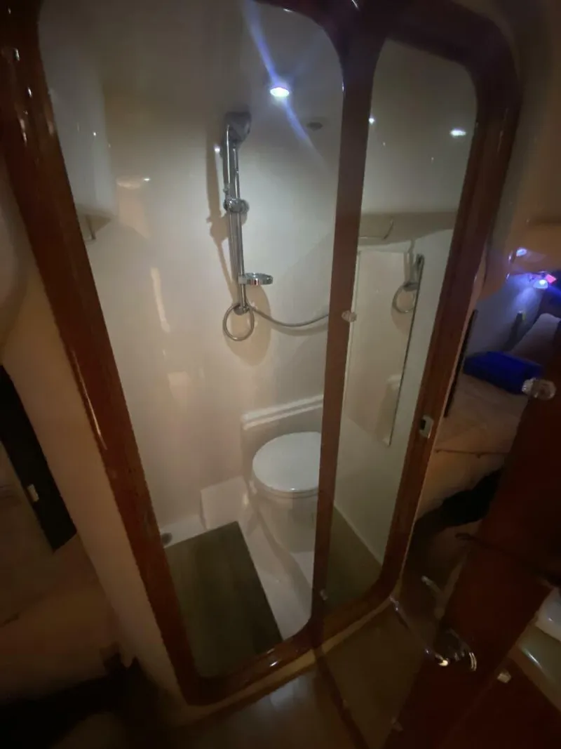 Slide: The Image of Bathroom interior of 2011 Regal 46 Sport Coupe yacht, featuring shower and toilet. - 10