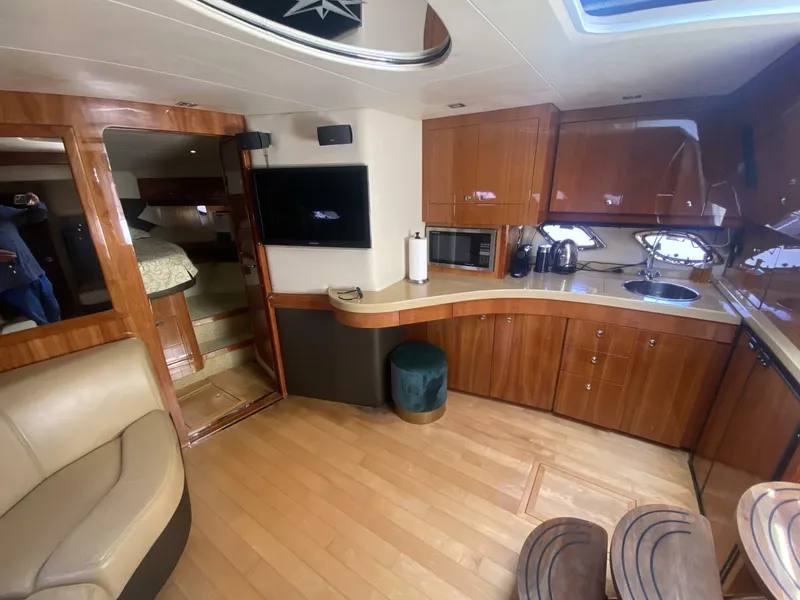 Slide: The Image of Luxurious interior of 2011 Regal 46 Sport Coupe yacht with modern kitchen and seating area. - 13