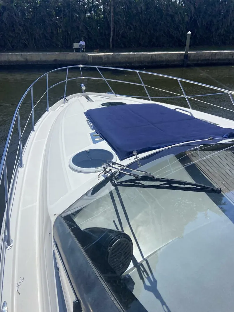 Slide: The Image of 2011 Regal 46 Sport Coupe boat with sleek deck design and blue sunpad. - 5