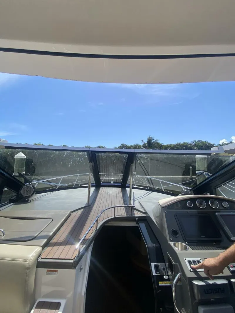 Slide: The Image of 2011 Regal 46 Sport Coupe yacht cockpit with modern controls and open sky view. - 6