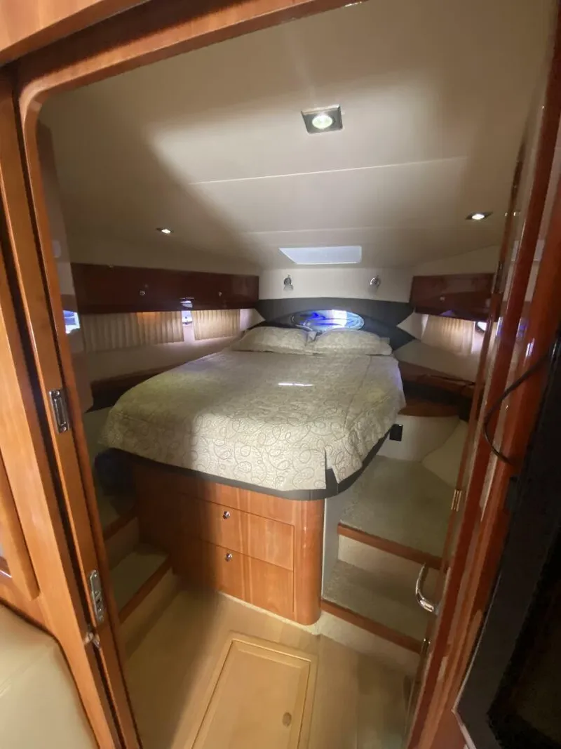 Slide: The Image of Interior cabin of 2011 Regal 46 Sport Coupe with cozy bed and wooden furnishings. - 9