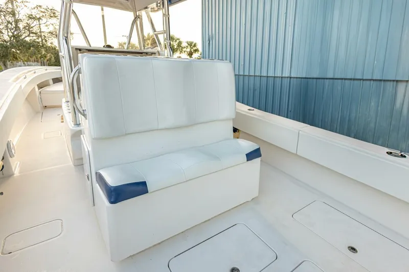 Slide: The Image of 2012 Invincible 36 Open Fisherman boat interior with white seating and blue accents. - 11
