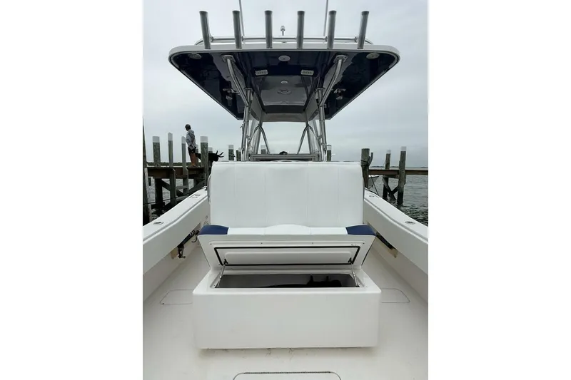 Slide: The Image of 2012 Invincible 36 Open Fisherman boat with open storage compartment, dockside view. - 12