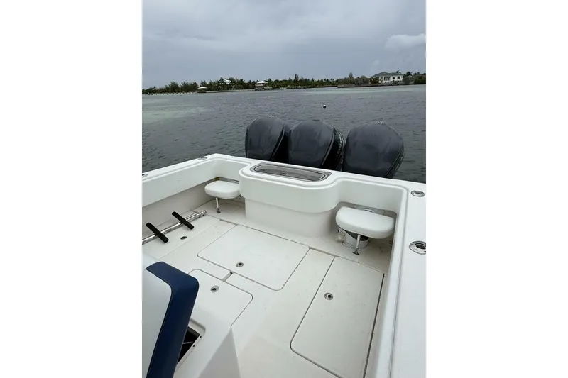 Slide: The Image of 2012 Invincible 36 Open Fisherman boat with triple engines on calm water. - 17
