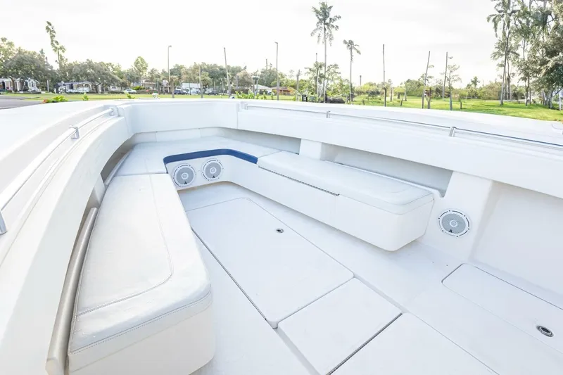 Slide: The Image of 2012 Invincible 36 Open Fisherman boat interior with white seating and speakers. - 5