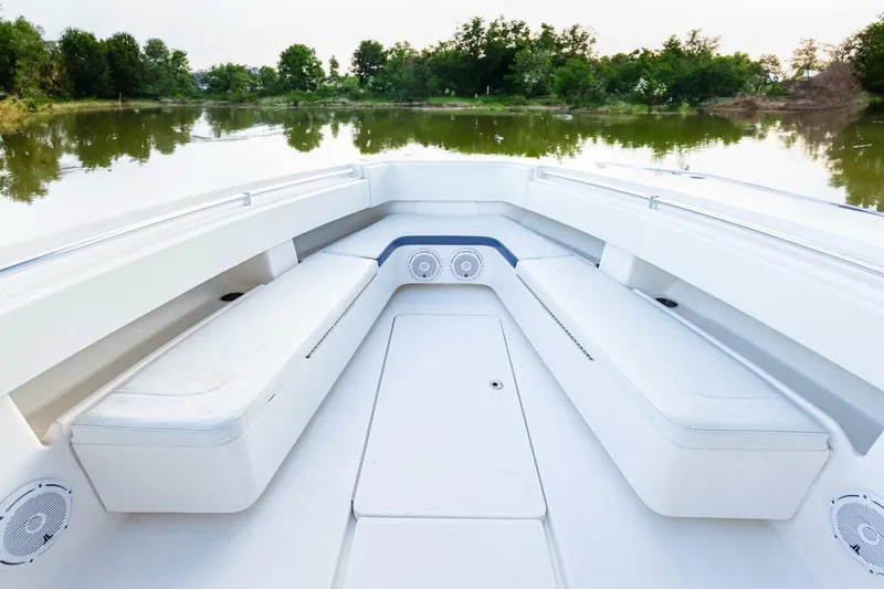 Slide: The Image of 2012 Invincible 36 Open Fisherman boat interior with white seating, on a calm lake. - 6
