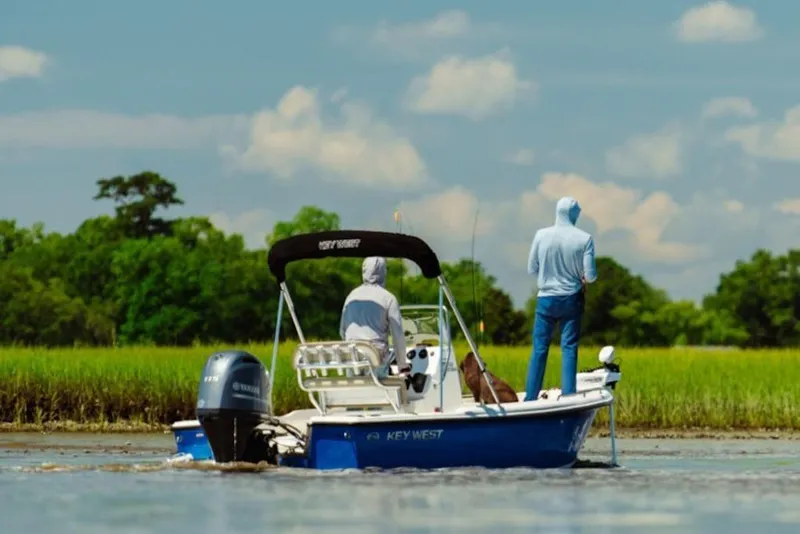 The Image of 2026 Key West 1720 Center Console boat on a serene river with two people fishing. - 1