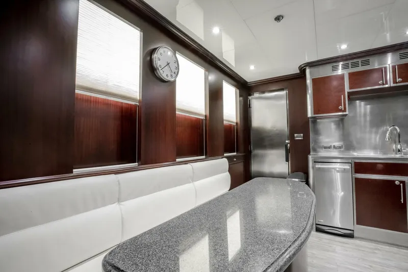 Slide: The Image of Luxurious yacht interior with modern kitchen, sleek countertops, and elegant wood paneling, Horizon Model Tri-Deck 2009. - 13